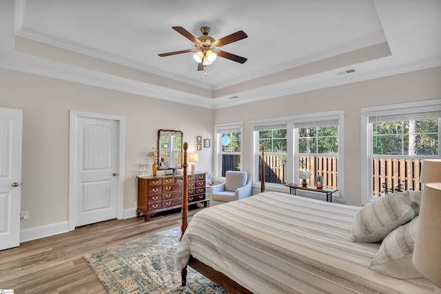 bedroom with ornamental molding, hardwood / wood-style flooring, and ceiling fan