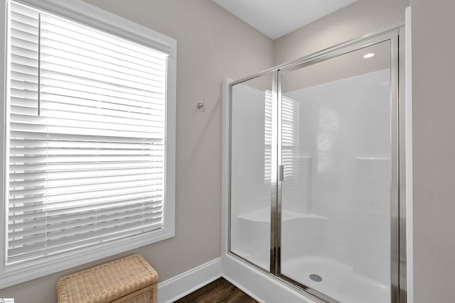 bathroom with walk in shower and hardwood / wood-style floors