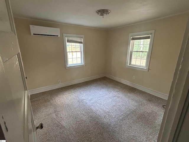 spare room with ornamental molding, a wall unit AC, and carpet flooring