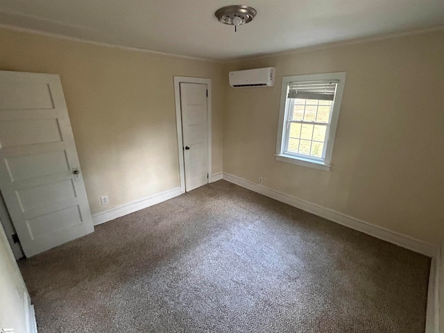 unfurnished bedroom with a wall mounted air conditioner, dark carpet, and a closet