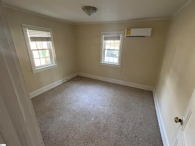 empty room with a wall unit AC, crown molding, and carpet flooring