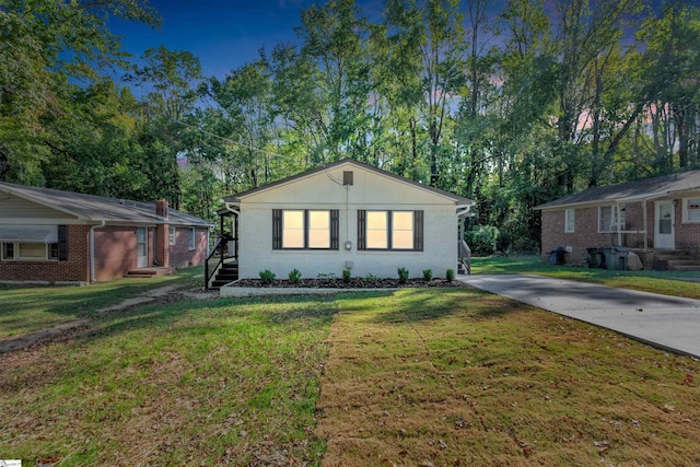 ranch-style house featuring a carport and a front yard