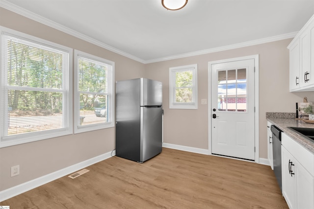 kitchen with crown molding, white cabinetry, stainless steel appliances, and light hardwood / wood-style flooring