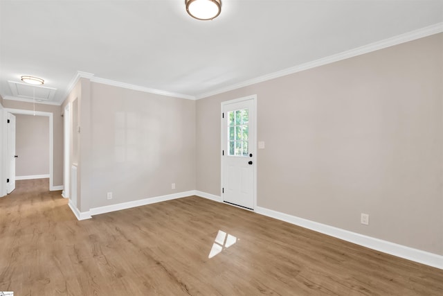 empty room featuring light hardwood / wood-style floors and ornamental molding