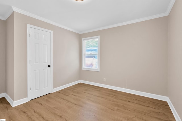 unfurnished room with ornamental molding and light hardwood / wood-style floors