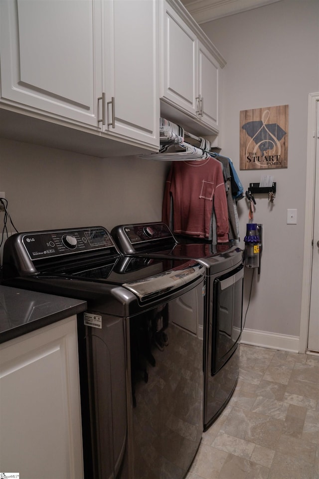 washroom featuring cabinets and independent washer and dryer