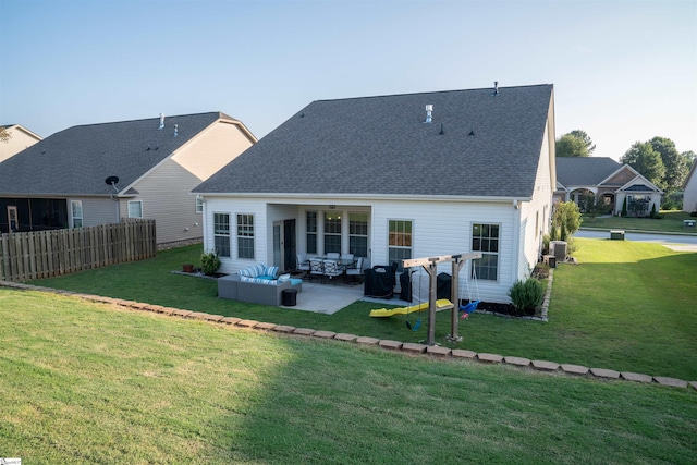 back of property featuring an outdoor living space, a patio, central AC unit, and a lawn