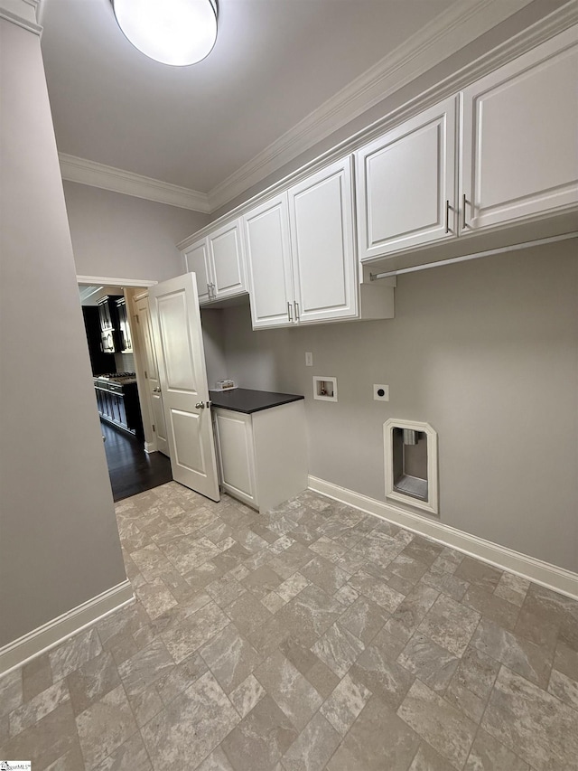 laundry room with electric dryer hookup, hookup for a washing machine, ornamental molding, and cabinets