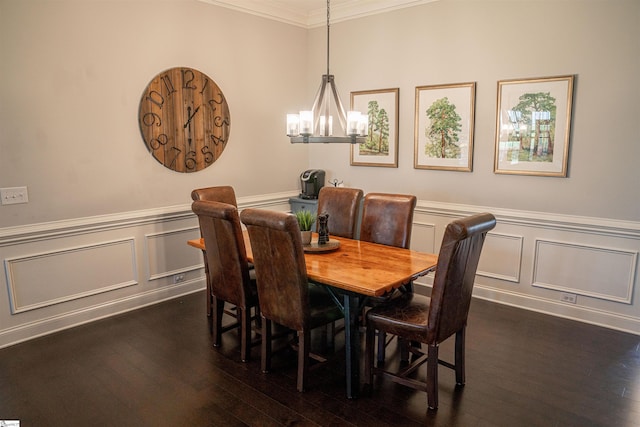 dining area with dark hardwood / wood-style flooring, ornamental molding, and a chandelier