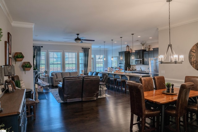 dining room featuring crown molding, dark hardwood / wood-style flooring, and ceiling fan with notable chandelier