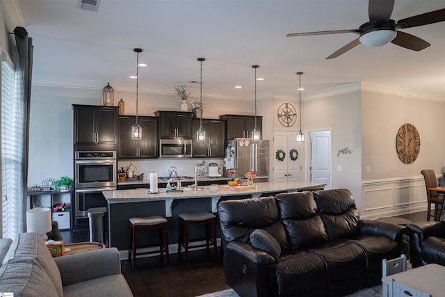 living room with ceiling fan, ornamental molding, and dark hardwood / wood-style flooring