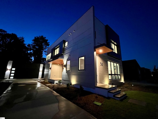 property exterior at night featuring a garage