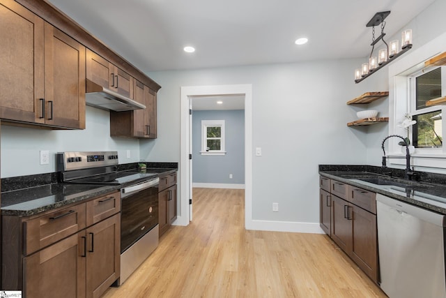 kitchen featuring appliances with stainless steel finishes, sink, light hardwood / wood-style floors, and a wealth of natural light