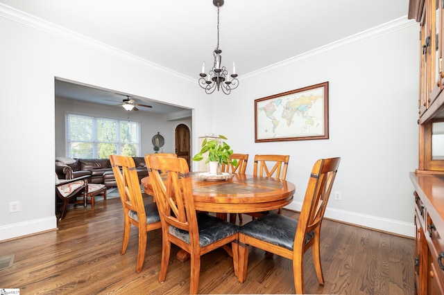 dining room featuring ornamental molding, ceiling fan with notable chandelier, and dark hardwood / wood-style flooring