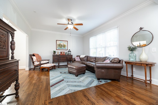 living room with ceiling fan, ornamental molding, and dark hardwood / wood-style floors