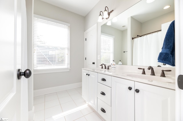 bathroom with vanity, a healthy amount of sunlight, and tile patterned floors