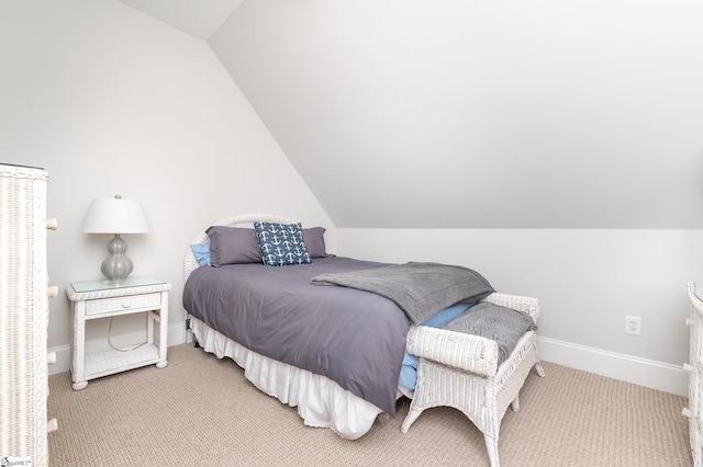 carpeted bedroom featuring lofted ceiling