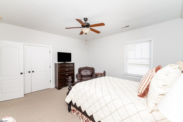 carpeted bedroom featuring a closet and ceiling fan