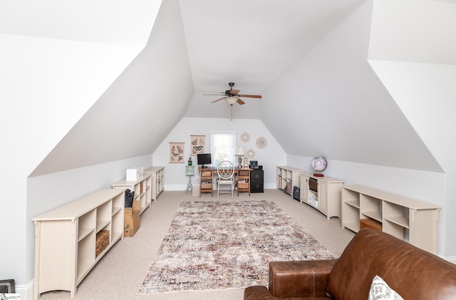 interior space with ceiling fan, light colored carpet, and vaulted ceiling