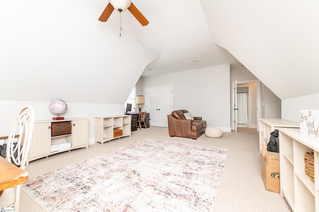 bonus room with vaulted ceiling, light colored carpet, and ceiling fan