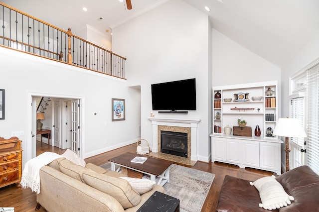 living room featuring dark wood-type flooring, high vaulted ceiling, and ceiling fan