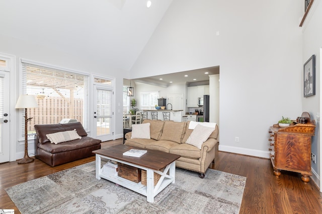 living room with high vaulted ceiling and hardwood / wood-style floors