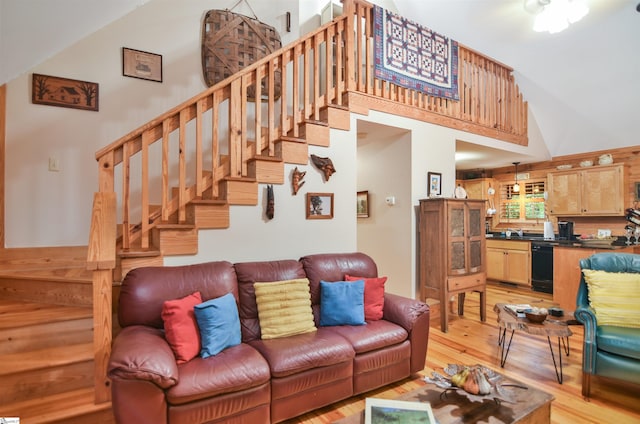 living room with a high ceiling and light hardwood / wood-style flooring