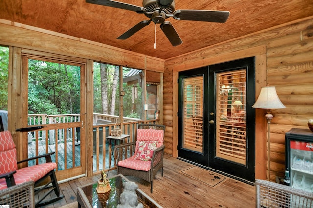 sunroom with ceiling fan and wooden ceiling