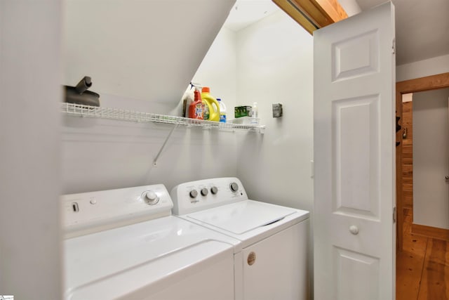 washroom featuring washer and dryer and wood-type flooring