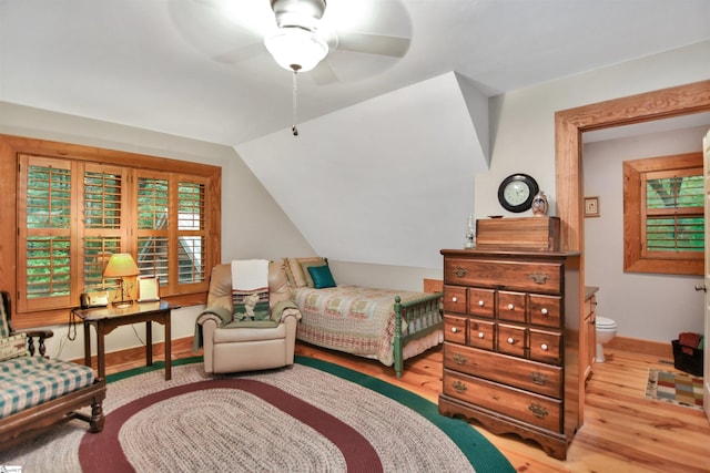 bedroom featuring connected bathroom, ceiling fan, lofted ceiling, and light hardwood / wood-style floors