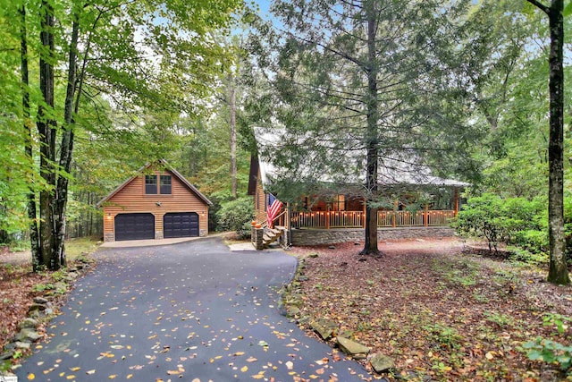 exterior space with a garage and an outbuilding