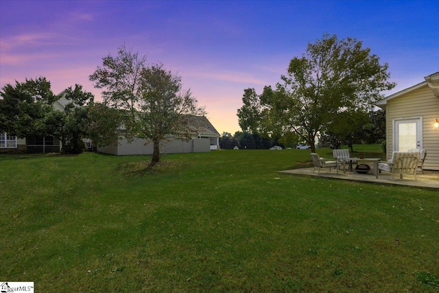 yard at dusk with a patio