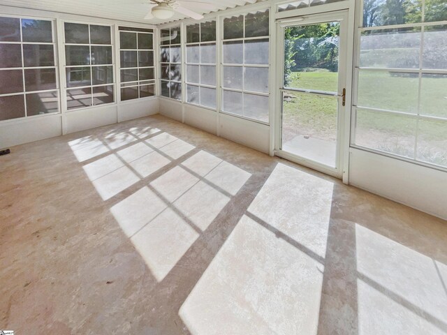 unfurnished sunroom featuring ceiling fan