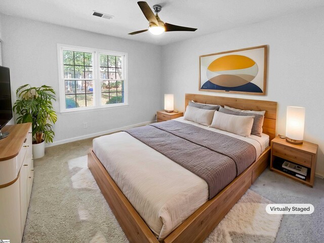 bedroom with visible vents, baseboards, ceiling fan, and light colored carpet