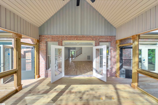 unfurnished sunroom featuring lofted ceiling and wood ceiling