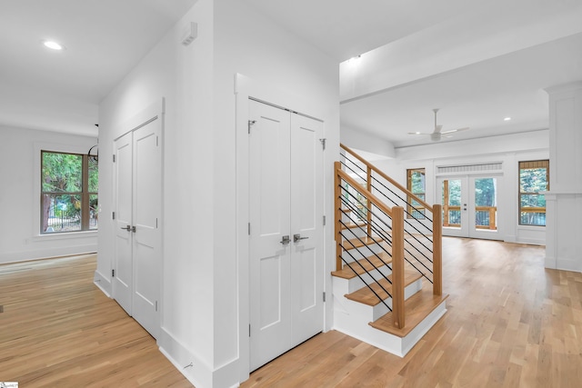 hall featuring french doors and light hardwood / wood-style flooring