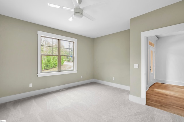 carpeted empty room with ceiling fan