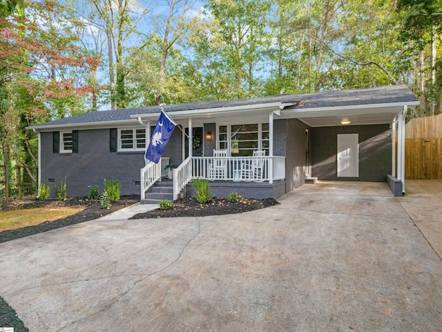 ranch-style house with a carport and a porch