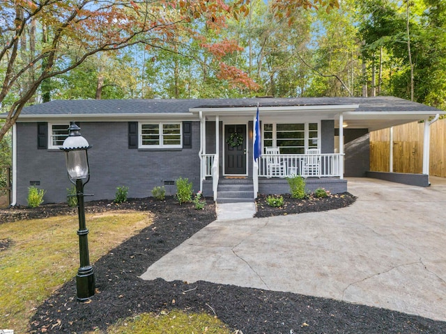 ranch-style house featuring a carport and a porch