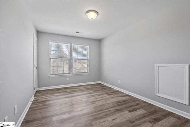 spare room with wood-type flooring