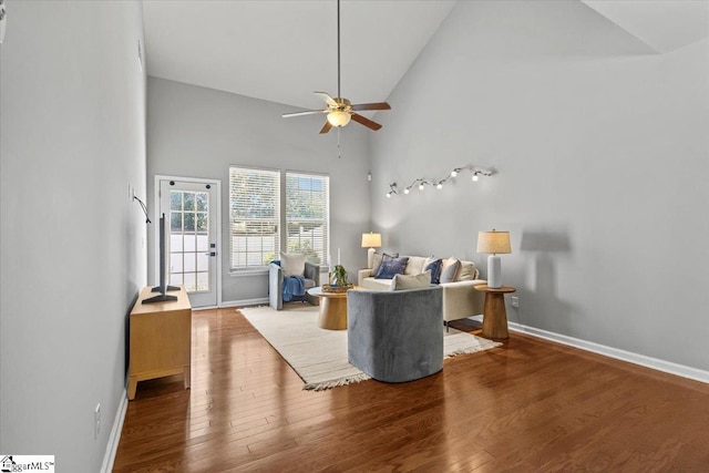 living room featuring hardwood / wood-style flooring, high vaulted ceiling, and ceiling fan