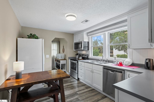 kitchen featuring white cabinetry, stainless steel appliances, sink, and dark hardwood / wood-style floors