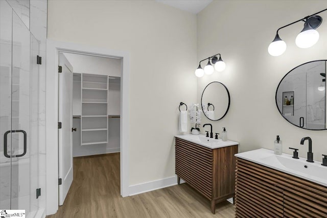 bathroom with vanity, hardwood / wood-style flooring, and a shower with shower door