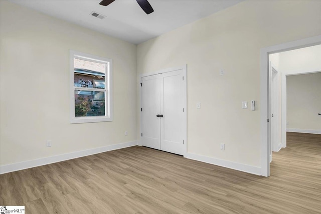 unfurnished bedroom featuring light hardwood / wood-style flooring, a closet, and ceiling fan