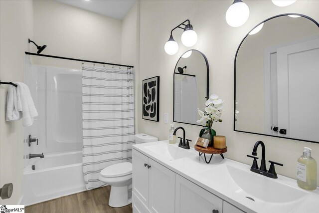 full bathroom featuring vanity, toilet, shower / bath combo with shower curtain, and hardwood / wood-style floors