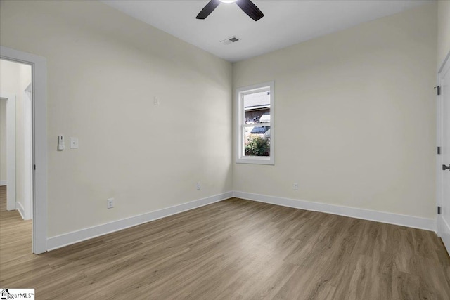 empty room with light hardwood / wood-style floors and ceiling fan