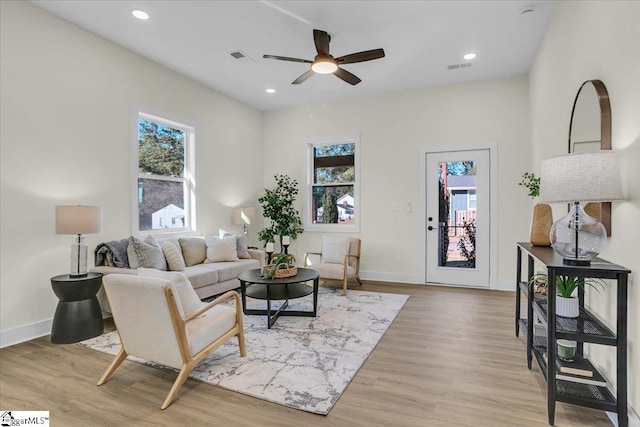 living room with ceiling fan and light wood-type flooring