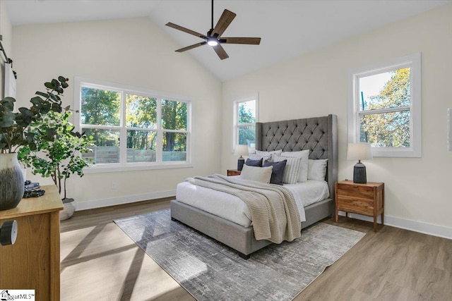 bedroom featuring ceiling fan, multiple windows, and hardwood / wood-style floors