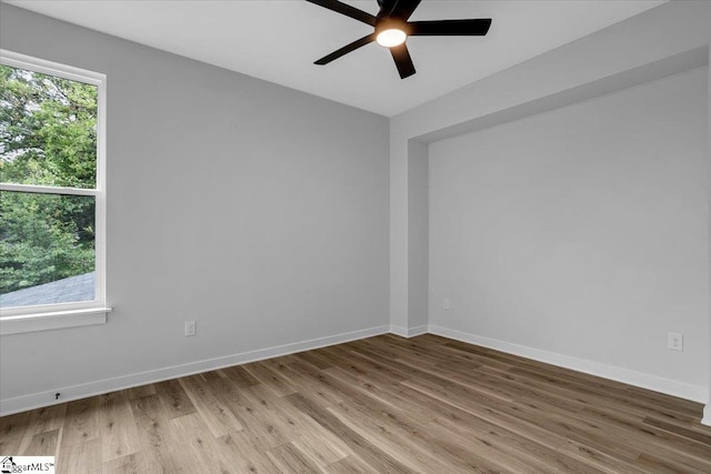 empty room featuring hardwood / wood-style floors and ceiling fan