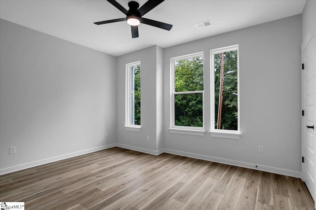 empty room featuring light hardwood / wood-style flooring, plenty of natural light, and ceiling fan